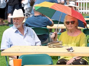 Visitors find shade from the sun