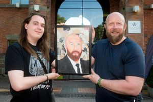 Telford College art student Harvey Ryder unveils his portrait to John Wilkinson, who works at Weston Park as part of the security team
