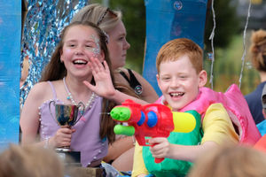 11 year old Amelia Davies with the trophy for the best children’s float and her eight year old brother George with a water pistol on the Atlantis float. Andy Compton image