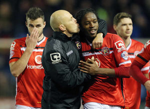 Jon Witney Joint caretaker manager of Walsall kisses Romaine Sawyers of Walsall in celebration at full-time