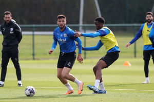 Okay Yokuslu under pressure from youngster Kevin Mfuamba (Photo by Adam Fradgley/West Bromwich Albion FC via Getty Images).