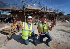 Site supervisor Tim Darrall and project lead John Hughes next to the site, where Tim laid the first brick
