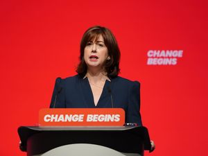 Lucy Powell giving a speech from behind a podium at Labour Party conference