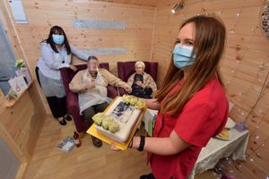 Regional manager Sue Dawson and, with the cake, activities co-ordinator Becky Jones helped the couple celebrate