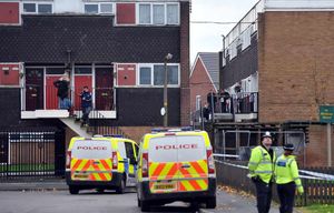 Police presence at the flats following the discovery of the body