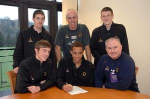 7Wolves manager Mick McCarthy and Academy Director Chris Evans Watch as Liam Hughes (left) Elliott Bennett sign contracts with Mark Salmon and Lee Collins (standing).