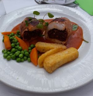 Chicken Ballentine with sauteed tomatoes and Basil wrapped in streaky bacon, tasty chunky chips