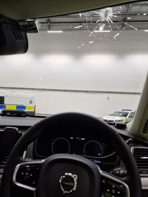 The smashed windscreen of the West Midlands Police patrol car after it was hit by a brick. Photo: West Midlands Police