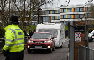 Police supervise the removal of travellers from the school car park at the Shenley Academy