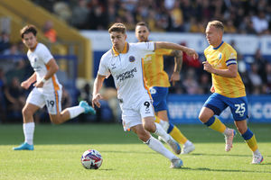 George Lloyd and Mansfield Town's Louis Reed (AMA)