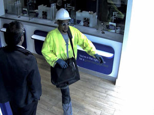 Supporting image for story: 'Armed' West Bromwich Building Society raider dressed as builder is caught on camera