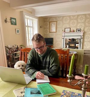 Andy, Eagle House owner, in the drawing room, researching its history as a Poor House.
