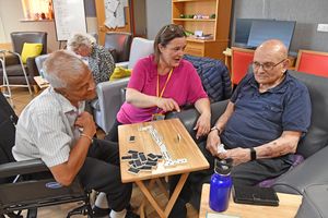 Ashok Patel, Jessica Davey and John Jukes take on a game of dominoes in the main lounge