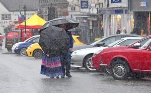 Visitors to the Bridgnorth Italian Moto Fest brave the horrendous downpours to view the cars on show