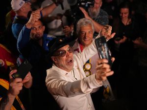 Supporters of George Simion react to the exit poll results