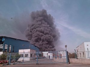 Black smoke rises in the sky after a massive explosion rocked a port near the southern port city of Bandar Abbas, Iran