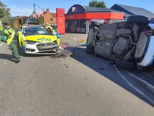 The overturned car and police vehicle which had extensive damage after the accident on Himley Road, Lower Gornal