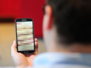 Man holding phone with blurry screen
