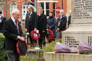 Llandrindod Wells Royal British Legion President Brian Jones lays a wreath watched by Llandrindod Wells Mayor Councillor Steve Deeks-D’Silva, Powys County Council Leader Councillor Jake Berriman, and Powys County Council Chief Executive Emma Palmer. Pic by Andy Compton