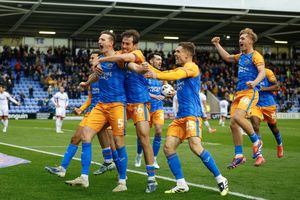 Will Boyle celebrates with his Shrewsbury Town teammates