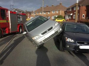 Supporting image for story: 'Please be careful where you park': Car left on two wheels after failed reverse manoeuvre
