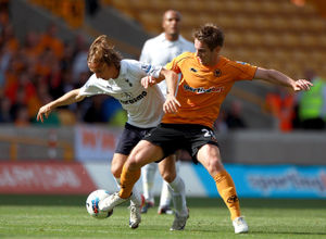 Luka Modric (left) and Wolverhampton Wanderers' Kevin Doyle (right) in action