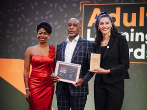 Karl Wilson (centre) with an Adult Learning Award for Learning for Work, presented to him by Awards hosts Nicola Beckford and Santina Bunting 