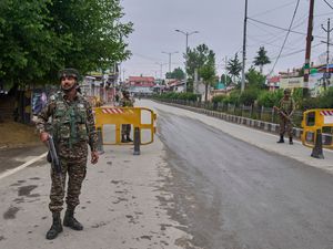 Indian paramilitary soldiers guard a temporary checkpoint on a road leading to the airport after loud explosions were heard in Srinagar, in Indian-controlled Kashmir