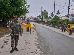 Indian paramilitary soldiers guard a temporary checkpoint on a road leading to the airport after loud explosions were heard in Srinagar, in Indian-controlled Kashmir