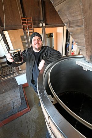 Sarah Hughes brewery manager Ricky Follos with a pint of Snowflake