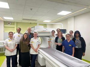 The nuclear medicine team with one of the new machines.