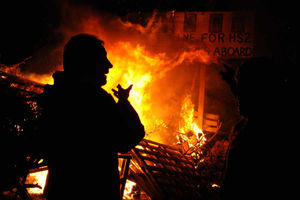 A man is silhouetted against the flames