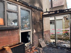 The gutted conservatory and shattered glass in the kitchen door