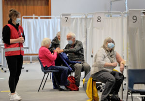 Patients are led into a bay to get the vaccine