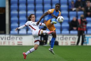 Ismeal Kabia of Shrewsbury Town battles with Harry Forster of Crawley Town