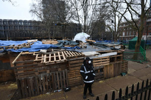 A security guard stands next to what remains of the anti-HS2 camp at Euston Square Gardens, London. Pic: Victoria Jones/PA Wire