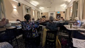 Stretching in a fun chair fit class led by Dr Belinda Bowd