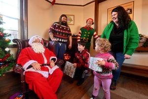 Santa and his elf say hello to the Rafferty family from Chirk: Daniel and Catrina with Neve (two) and Joseph (13)