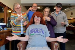 Pat Hirst having her head shaved to raise money for Macmillan Cancer Support.  Pat is pictured with her husband and members of the Castle Writers group that she is a part of. 