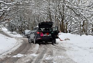 The scene around Aldridge after heavy snowfall.A driver tries to free his car in Bridle Lane.