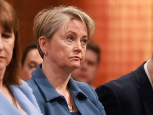 Home Secretary Yvette Cooper listens to the Prime Minister during a press conference on the Immigration White Paper in the Downing Street Briefing Room