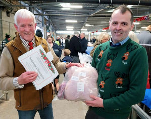 Auctioneer Jonny Dymond (right) and show judge Alan Tomlinson with the overall champion turkey from the Brisbourne family