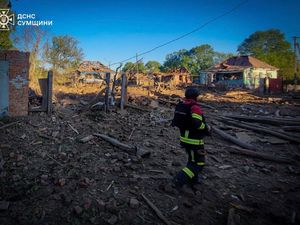 A rescue worker searches residential buildings destroyed by a Russian strike in Sumy, Ukraine