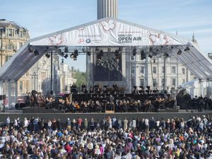 Members of the public watch the London Symphony Orchestra play a programme of Rachmaninov in Trafalgar Square, central London