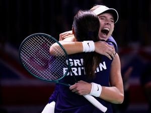 Katie Boulter, right, celebrates victory over Canada’s Leylah Fernandez with captain Anne Keothavong