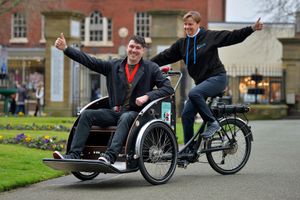 Mayor elect Jay Moore gets a ride in Oswestry's new rickshaw with cycle hub manager chris Jennings