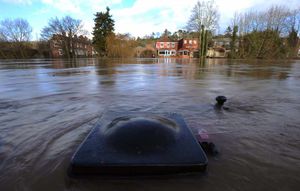 The top of a rubbish bin pokes out through the water