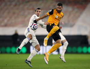 Leeds United's Pascal Struijk and Wolverhampton Wanderers' Willian Jose battle for the ball (PA)
