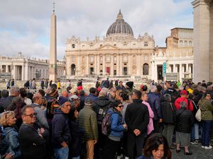 People wait in St. Peter’s Square to pay their respects to the late Pope Francis