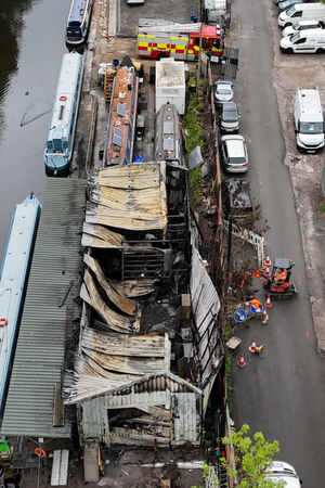 A view of the damage following a fire which engulfed a canal side boatyard workshop in Birmingham. Photo: Jacob King/PA Wire